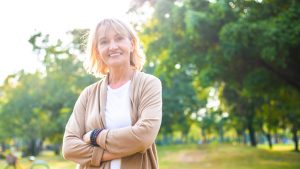 portrait of happy Caucasian senior woman in arms crossed looking