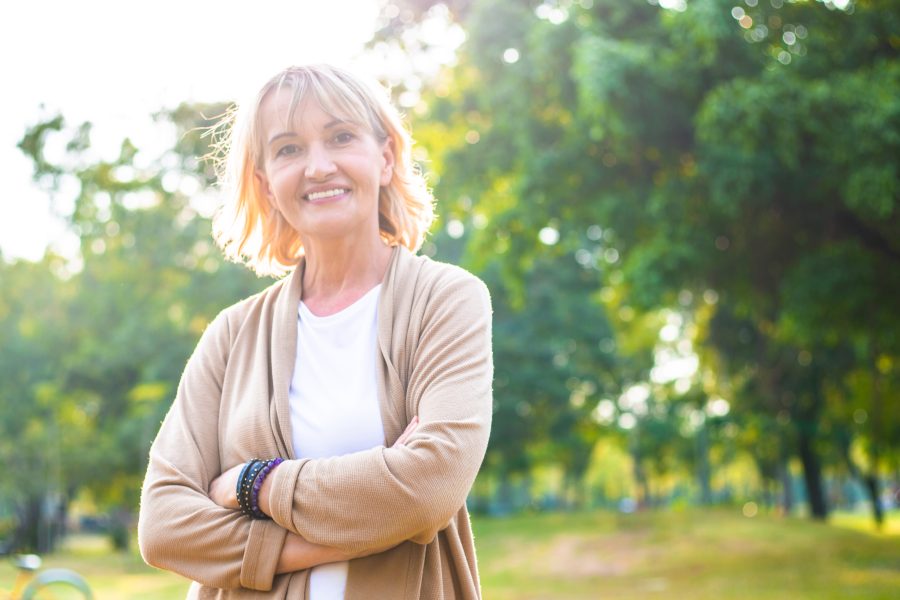 portrait of happy Caucasian senior woman in arms crossed looking
